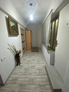 a hallway with white walls and a tile floor at Shirakatsi Guest House in Gyumri