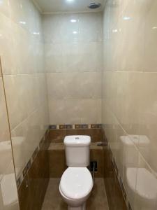 a bathroom with a white toilet and a shower at Shirakatsi Guest House in Gyumri