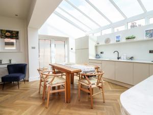 a kitchen with a table and chairs and a skylight at The Kingsway in Ilkley
