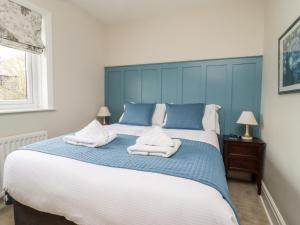 a bedroom with a large bed with towels on it at The Kingsway in Ilkley