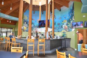 a restaurant with a bar with a fish mural at Gulf front condo in Panama City Beach