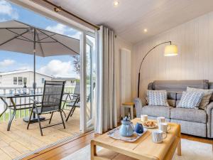 a living room with a couch and a table at Rosemary Lodge in Willington