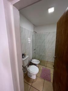 a small bathroom with a toilet and a sink at Apart Hotel Chilecito in Chilecito