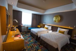 Hotel Ciputra Cibubur managed by Swiss-Belhotel International客房内的一张或多张床位