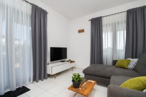 TV a/nebo společenská místnost v ubytování Apartments Slavica