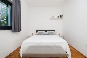 Postel nebo postele na pokoji v ubytování Apartments Slavica