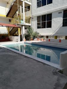 an empty swimming pool in front of a building at Posada El Balcon in Rincon de Guayabitos