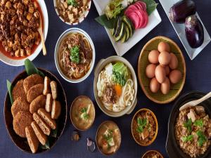 a table full of different types of food on plates at REF Kanku-Izumisano by VESSEL HOTELS in Izumi-Sano