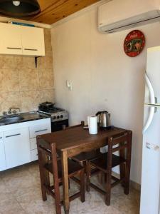 a kitchen with a wooden table and a stove at Bastian in Mercedes