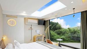 a bedroom with a bed and a large window at 日月對白 日月潭 2023全新開幕 in Yuchi