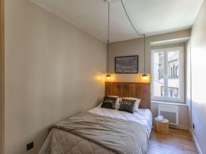 a bedroom with a bed with two pillows on it at Maison spacieuse au centre de Cauterets, avec terrasse, garage, et proche commodités et télécabines. - FR-1-401-260 in Cauterets +4 photos