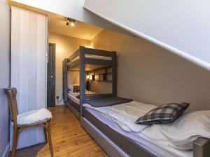 a bedroom with two bunk beds and a chair at Maison Cauterets, 7 pièces, 8 personnes - FR-1-401-260 in Cauterets