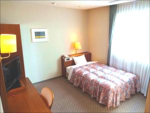 Una cama o camas en una habitación de Shingu UI Hotel