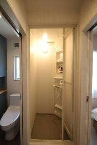 a bathroom with a toilet and a walk in shower at misora 合津港近く松島の自然と海を満喫できる平屋の貸切別荘 in Kami Amakusa