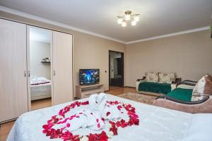 a bedroom with a bed with flowers on it at Просторная 1ком квартира у Набережной Астаны in Astana