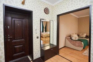 a room with a door and a mirror at Просторная 1ком квартира у Набережной Астаны in Astana