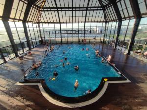 a group of people in a pool in a building at Happiest Homestay 1 - Manor Crown Hue in Hue