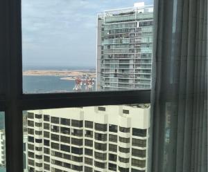 a view of a large building from a window at LAKNA HOUSE in Colombo