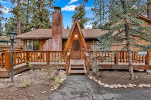 a log home with a staircase leading to the front door at The Lost Compass- Hot Tub- Games- Walk To Lake or Marina in Big Bear Lake