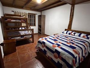 a bedroom with a bed in a room at QUINTA VACACIONAL DIEGO ALFONSO, MY house in Macas in Macas