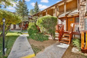 a house with a porch and a wooden stairway at Slopeside Views Chalet- Hot Tub- Resort View Cozy Condo in Big Bear Lake