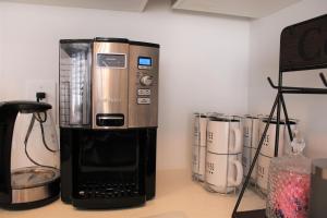 a coffee maker sitting on top of a counter at New Town House Barrie South in Barrie