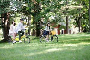 a group of people riding bikes in a park at Karuizawa Prince Hotel West in Karuizawa