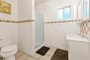 a white bathroom with a toilet and a sink at Cozy Summit- Cozy Central Resort Chalet- Minutes to Activities in Big Bear Lake +14 photos