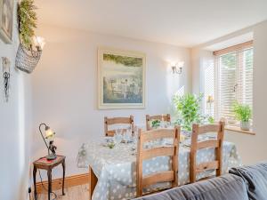 a dining room with a table and chairs at Eynhallow in Cheddar