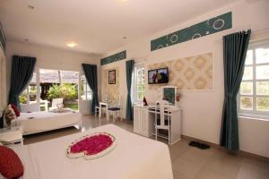 a large living room with a white table and a room at Muine Sun & Sea Resort in Mui Ne