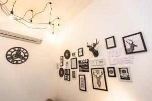 a wall with a bunch of pictures on it at Paradigm Residence Paradigm Mall 1 Bedroom 4pax in Johor Bahru