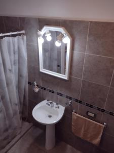 uma casa de banho com um lavatório e um espelho em Departamento amoblado Rio Cuarto em Río Cuarto