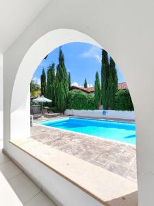 an archway over a swimming pool in a villa at Ayia Napa Villa with private pool in Ayia Napa