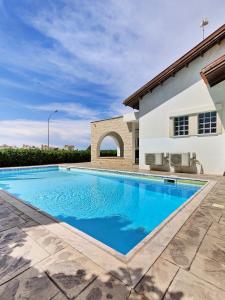 a swimming pool in front of a house at Ayia Napa Villa with private pool in Ayia Napa