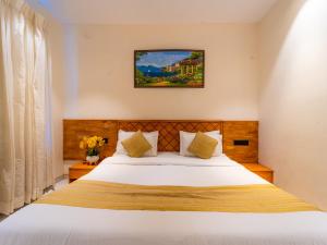 a bedroom with a large white bed in a room at Red Button Resort in Mahabaleshwar
