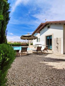 a patio with a table and chairs and an umbrella at Ayia Napa Villa with private pool in Ayia Napa