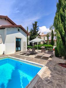 a swimming pool in front of a house at Ayia Napa Villa with private pool in Ayia Napa