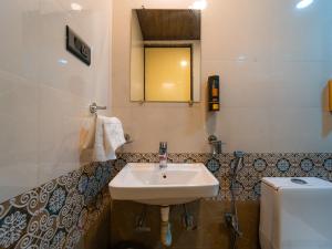 a bathroom with a sink and a toilet at Red Button Resort in Mahabaleshwar