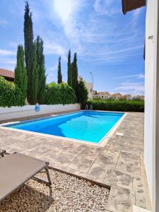 a swimming pool in a yard next to a house at Ayia Napa Villa with private pool in Ayia Napa