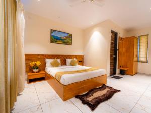 a bedroom with a large bed in a room at Red Button Resort in Mahabaleshwar