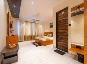 a hotel room with a bed and a large door at Red Button Resort in Mahabaleshwar