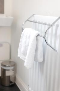 a towel rack with towels hanging on a wall at Stunning Two-Bedroom Apartment at A3REE, Free Parking, near Cribbs Causeway Mall in Bristol