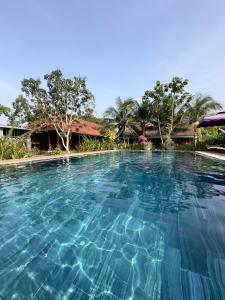 a large swimming pool in a resort at Boutique Lodge Can Tho Homestay in Can Tho
