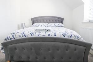 a bedroom with a bed with a blue and white comforter at Stunning Two-Bedroom Apartment at A3REE, Free Parking, near Cribbs Causeway Mall in Bristol