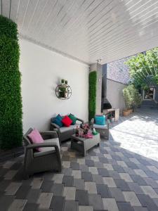 a living room with couches and chairs on a patio at Cool Blue Interior SELF CHECK IN in Yerevan