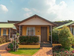 a house with a front yard with plants at Red Button Resort in Mahabaleshwar