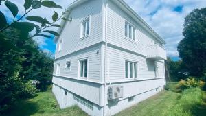 a white house with windows on the side of it at Sundsvall By M - Basement Studio in Sundsvall