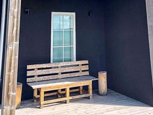 a wooden bench sitting in front of a window at 8 person holiday home in VEMDALEN in Vemdalen