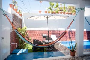 a patio with a hammock and a pool at Casa Blanca in Chiquimulilla