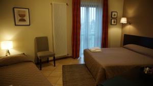 Postel nebo postele na pokoji v ubytování HOTEL DEL CORSO